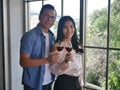 The asian young man and woman lovers drinking red wind together to celebrate