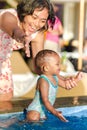 Asian Young Mother Encourage Toddler Having Fun at Swimming Pool Royalty Free Stock Photo