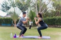 Mother, father and child daughter doing exercising together with dumbbells is fun outdoors