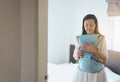 Asian young mother with her son in a baby carrier in bedroom,Feeling happy Royalty Free Stock Photo