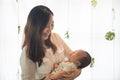 Asian young mother holding her baby in the bosom Royalty Free Stock Photo