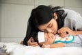 Asian young mother take care male baby gotten fever illness in bedroom