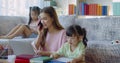 Asian Young mother working at home with two daughters Royalty Free Stock Photo