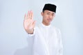 Asian young muslim man with open hand doing stop sign with serious and confident expression, defense gesture Royalty Free Stock Photo