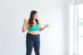 Asian young overweight oversized fat chubby plump healthy female sportswoman in sportswear sports bra legging standing smiling
