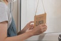 Asian young owner retail,coffee shop woman turning sign board to closed with wearing face mask,protection to pandemic of