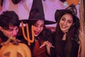 Asian young people in costumes celebrating halloween. Group of friends having fun at party in nightclub Royalty Free Stock Photo