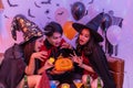 Asian young people in costumes celebrating halloween. Group of friends having fun at party in nightclub Royalty Free Stock Photo