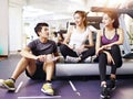 Asian young people talking in gym Royalty Free Stock Photo