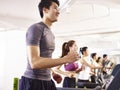 Asian young people working out on treadmill Royalty Free Stock Photo