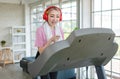 Asian young pretty cheerful happy healthy fitness girl in sexy sportswear with headphones listening to music playlist walking Royalty Free Stock Photo