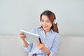 Asian young pretty woman work on tablet listen music headphones Royalty Free Stock Photo