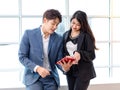 Asian young professional businessman employee in formal suit holding touchscreen tablet computer showing presenting discussing Royalty Free Stock Photo