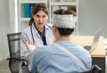 Asian young professional female practitioner doctor in white lab coat with stethoscope holding skull model showing explaining to Royalty Free Stock Photo