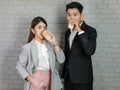 Asian young professional successful businessman and businesswoman management team in formal wears standing posing taking break Royalty Free Stock Photo