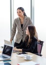 Asian young professional successful businesswoman employee colleagues in formal suit sitting standing in meeting room, typing