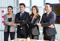 Asian young professional successful male and female businessmen and businesswomen in formal business suit standing side by side