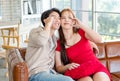 Asian young romantic handsome male boyfriend playing touching beautiful female girlfriend cheek sitting smiling cuddling showing Royalty Free Stock Photo