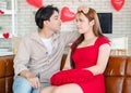 Asian young romantic handsome male boyfriend playing touching beautiful female girlfriend cheek sitting smiling cuddling showing Royalty Free Stock Photo