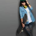 Asian young skater girl holding a skateboard Royalty Free Stock Photo