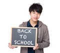 Asian young student with blackboard showing back to school Royalty Free Stock Photo