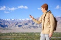 Asian young traveler looking at compass in Himalaya mountain view background in Leh, Ladakh, India Royalty Free Stock Photo