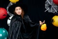 Asian young witch Halloween woman portrait holding pumpkins basket with copy space