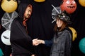 Asian young wizard Halloween man portrait standing with witch Halloween woman shaking hand