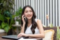 Asian young woman answer the phone and talking with positive and happiness emotional.Attractive female talkin in smartphone smile Royalty Free Stock Photo