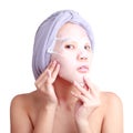 Asian young woman applying facial peel off mask Royalty Free Stock Photo
