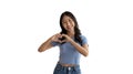 Asian young woman with bright smile making heart symbol shape with hands Royalty Free Stock Photo