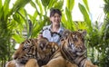 Asian young woman catches the tiger tail