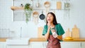 Asian young woman dancing in kitchen room Royalty Free Stock Photo