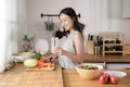Asian young woman drinking fresh water in kitchen at home , healthy lifestyle concept Royalty Free Stock Photo