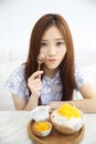 Asian young woman eating Shaved ice with milk and coconut