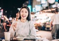 Asian young woman enjoy  street food in  Night Market Royalty Free Stock Photo