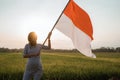Asian young woman flapping Indonesian flag Royalty Free Stock Photo