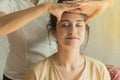 Asian young woman getting head thai massage in spa.She is very relaxed. concept relaxation and health spa Royalty Free Stock Photo