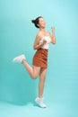 Asian young woman jumping and expressing happiness