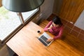 Asian Young Woman make a call on smart phone and working on note Royalty Free Stock Photo