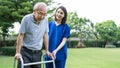 Asian young woman nurse at nursing home take care disabled senior elderly man. Caregiver doctor serve physical therapy for older p Royalty Free Stock Photo