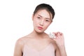 Asian young woman with perfact skin holding cosmetic product.