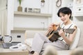 Asian young woman is playing guitar on sofa at home , happy relaxing lifestyle concept Royalty Free Stock Photo