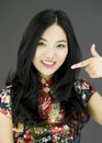 Asian young woman pointing at herself over colored background