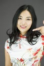 Asian young woman pointing at herself over colored background