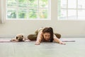 Asian young woman practice yoga with dog pug breed enjoy and relax with yoga at home Royalty Free Stock Photo