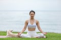 Asian young woman practice yoga lotus pose to meditation with dog on the beach feeling so happiness and cheerful Royalty Free Stock Photo