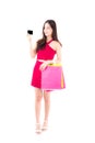 Asian young woman with red dress holding a credit card and bag paper colorful isolated Royalty Free Stock Photo