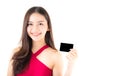 Asian young woman with red dress holding a credit card thinking to spend money lots isolated Royalty Free Stock Photo