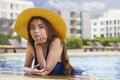 Asian young woman relaxing in swimming pool. Enjoying summe Royalty Free Stock Photo